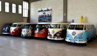 Vintage Volkswagen Kombi bus (van, transporter or camper) are parked in a garage after being completly restored by mechanics of the 