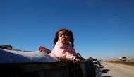 A displaced Iraqi child flees with her family during a battle with Islamic State militants in Kokjali village near Mosul, Iraq November 3, 2016. REUTERS/Ahmed Jadallah