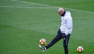 Real Madrid's French coach Zinedine Zidane plays with a ball during a training session at Valdebebas Sport City in Madrid on November 5, 2016 on the eve of their Spanish Liga football match against Leganes. / AFP / PIERRE-PHILIPPE MARCOU
