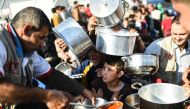 Displaced Iraqi boys wait to receive food at a refugee camp in the Khazir Region, between Arbil and Mosul on November 5, 2016. Aid workers have warned of a major humanitarian crisis when fighting begins in earnest for Mosul, which is home to more than a m