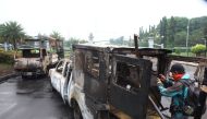 Wrecked cars are seen after the protests against Governor Basuki 