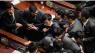 Newly elected lawmaker Baggio Leung is restrained after attempting to read out his Legislative Council oath at Legco in Hong Kong on November 2, 2016. (AFP)