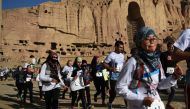 Afghan and international marathon runners take part in a marathon on a course that took them past the destroyed Buddha statues in Bamiyan province on November 4, 2016. Female athletes wearing headscarves raced November 4 against a backdrop of russet-hued 