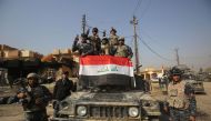 Iraqi forces flash the sign for victory in the Hamam al-Alil area, about 14 kilometres from the southern outskirts of Mosul, on November 7, 2016 after recapturing it from Islamic State (IS) group jihadists during the ongoing operation to retake Mosul. AFP