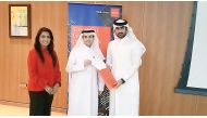 Abdullah Al Jaidah (right), ACCA member, honouring Yusef Al Naama at the event, while Fazeela Gopalani, ACCA Head of Education, looks on.