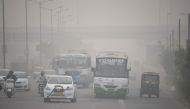 In this photograph taken on November 7, 2016, Indian commuters journey along a major road as heavy smog covers New Delhi. India's top court on November 8 gave the federal government two days to chalk out a plan to tackle alarming levels of smog in Delhi, 