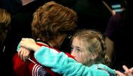 A girl hugs a woman as she watches voting results at Democratic presidential nominee former Secretary of State Hillary Clinton's election night event at the Jacob K. Javits Convention Center November 8, 2016 in New York City. John Moore/Getty Images/AFP