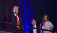 Republican presidential elect Donald Trump (L) waves to the crowd with his son Baron (C) and wife Melania (R) during election night at the New York Hilton Midtown in New York on November 9, 2016. / AFP.