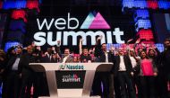 Irish founder & CEO of Web Summit Paddy Cosgrave (CR with eyeglasses) and other participants wave during the Nasdaq Bell opening ceremony at the main stage of the Web Summit at Parque das Nacoes, in Lisbon on November 9, 2016. Europe's largest tech event 