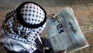 A Palestinian man reads the Al-Quds newspaper depicting images newly elected U.S. President Donald Trump and Democratic presidential nominee Hillary Clinton in Jerusalem's Old City November 9, 2016. REUTERS/Ammar Awad