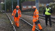Crash investigators work on the tracks near the site of an accident where a tram overturned killing 7 people and injuring 50 passengers in Croydon, south London, Britain November 10, 2016. REUTERS/Neil Hall
