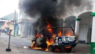 A police car burns in flames at Catemaco community in Veracruz, Mexico on November 12, 2016, during a protest after priest Jose Luis Sanchez disappeared. AFP / EDUARDO MURILLO
