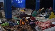 Pakistani devotees take shelter after a suicide bomb attack near a shrine of Sufi saint Shah Noorani, some 750 kilometres (460 miles) south of Quetta, on November 13, 2016. AFP / ASIF HASSAN
