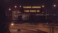 A tsunami warning alert is seen on a notice board above State Highway 1 in Wellington early on November 14, 2016 following an earthquake centred some 90 kilometres (57 miles) north of New Zealand's South Island city of Christchurch. A powerful 7.8 magnitu