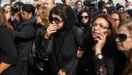 Poussy Chalabi (C), wife of Egyptian actor Mahmoud Abdel Aziz, mourns during his funeral in a suburb of Cairo on November 13, 2016. Abdel Aziz, who died the day before at the age of 70, starred in more than 90 feature films and worked under some of Egypt'