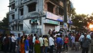 Indian customers queue outside a bank near a shuttered ATM as they wait to try to exchange 500 and 1000 INR notes and deposit money in Siliguri on November 13, 2016. Prime Minister Narendra Modi November 13 made an emotional appeal to people to make India