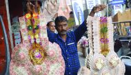 A man sells garlands made of Indian currency notes at a market in Jammu, India, November 13, 2016. REUTERS/Mukesh Gupta