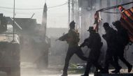 Iraqi Special Forces 2nd division soldiers come under fire from Islamic State (IS) group fighters while running across an intersection as they try to push forward in the Karkukli neighbourhood of Mosul on November 13, 2016.   AFP / Odd ANDERSEN