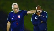 Qatar coach Jorge Fossati guides his team during a team training session. RIGHT: Qatar football players attend a training session ahead of their 2018 FIFA World Cup qualifying game against China today.