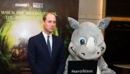 Britain's Prince William, Duke of Cambridge poses with an activist dressed as a white rhinoceros after delivering a speech at the Hanoi conference on illegal wildlife trade being held in Hanoi on November 17, 2016. AFP / STR