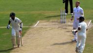 England's Ben Stokes (2R) watches as India's Cheteshwar Pujara (L) and Virat Kohli (R) run between the wickets during the first day of the second Test cricket match between India and England at the Dr. Y.S. Rajasekhara Reddy ACA-VDCA Cricket Stadium in Vi