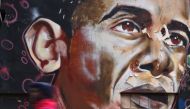 A man walks past a mural of US President Obama painted on a wall in Nairobi on November 8 2016 (AFP)