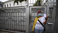 People demonstrate against the government of Venezuelan President Nicolas Maduro and the lack of medicine in the country, in front of the Nunciature in Caracas, on November 17, 2016. Shortages of food, medicine and basic supplies have sparked riots and lo