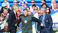 Chelsea's manager Jose Mourinho (Right) and Arsenal's manager Arsene Wenger (left) being kept apart by the fourth official referee during their Premier League match at Stamford Bridge in London, England in this October 5, 2014 file Photo. 
