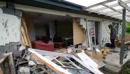 A man looks at damage to a house in Waiau town, some 80 kms to the south of Kaikoura, on November 16, 2016, after an earthquake hit New Zealand just after midnight on Monday. AFP / Matias Delacroix