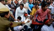 An Indian policeman pulls at a member of the Indian Youth Congress as he tries to detain him, during a protest against the demonetisation in New Delhi on November 18, 2016. India's government asked its citizens to put up with what it called the 