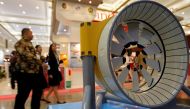 People walk past a model of marine turbine for generating electricity from underwater tidal streams, at an infrastructure expo in Jakarta, Indonesia, November 11, 2016. Picture taken November 11, 2016. REUTERS/Iqro Rinaldi