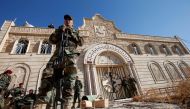 Peshmerga forces stand guard during a procession to erect a new cross over the Mar Korkeis church, after the original cross was destroyed by Islamic State militants, in the town of Bashiqa, Iraq, November 19, 2016. REUTERS/Azad Lashkari