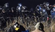 Police confront protesters with a rubber bullet gun during a protest against plans to pass the Dakota Access pipeline near the Standing Rock Indian Reservation, near Cannon Ball, North Dakota, U.S. November 20, 2016. REUTERS/Stephanie Keith 
