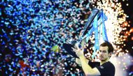 Andy Murray celebrates with the trophy after winning the men's singles final against Novak Djokovic of the ATP World Tour Finals tennis tournament in London on Sunday.