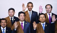 US President Barack Obama with Thailand's Deputy Prime Minister Prajin Juntong, Vietnam's President Tran Dai Quang; Indonesia's Vice President Jusuf Kalla, Japan's Prime Minister Shinzo Abe and South Korea's Prime Minister Hwang Kyo-Ahn wave during the tr