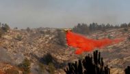 A firefighting plane drops fire retardant during a wildfire, near the communal settlement of Nataf, close to Jerusalem November 23, 2016. REUTERS/Ronen Zvulun