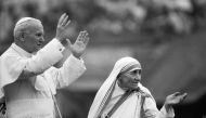 This February 03 1986 photo shows Mother Teresa and Pope John Paul II waving to well-wishers at the Nirmal Hriday Home in Calcutta (AFP JEAN-CLAUDE DELMAS)