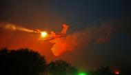 A Russian firefighter plane helps extinguish a new fire that broke out in the Israeli town of Nataf, west of the Arab Israeli town of Abu Ghosh, along the border with the occupied West Bank on November 25, 2016. Foreign firefighting planes helped Israel t