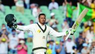 Australian batsman Usman Khawaja celebrates after scoring a century against South Africa during the second day of the Third Test in Adelaide yesterday