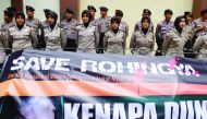 Indonesian police form a human barricade as Muslims hold a rally outside of Myanmar embassy against 