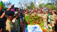 Border Security Force officers salute at the coffin of Sambhu Satmura, who was killed in a land mine blast at the border, during a wreath laying ceremony in Agartala, yesterday.