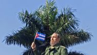 (FILES) This file photo taken on January 26, 2001 shows Cuban President Fidel Castro waving a flag during a visit 27 January, 2001, to the Havana neighborhood of San Jose de las Lajas. AFP / ADALBERTO ROQUE