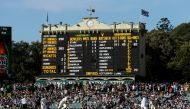 Australian bowler Jackson Bird delivers to South Africa's Stephen Cook in front of the old scoreboard during the third day of the Third Test cricket match in Adelaide. (Reuters/Jason Reed)