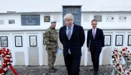 Britain's Foreign Secretary Boris Johnson (C) and British ambassador to Afghanistan Dominic Jermey (R) visit the British cemetery in Kabul, Afghanistan November 26, 2016. REUTERS/Mohammad Ismail