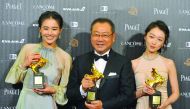 Chinese actress Ma Sichun (left), Chinese actor Fan Wei (centre) and Chinese actress Zhou Dongyu display trophies after winning the Best Leading Actor and the Best Leading Actress during the 53rd Golden Horse Film Awards in Taipei yesterday