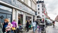 (FILES) This file photo taken on February 22, 2016 shows people walking past the Wefood supermarket that sells food past its sell-by date at Amager in Copenhagen, Denmark. AFP / SCANPIX DENMARK / Soren Bidstrup