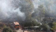 Israeli firefighters try to extinguish fire in a forest near the Halamish Jewish accommodation unit in Deir Nidham town of Ramallah, West Bank on November 26, 2016. (Issam Rimawi - Anadolu Agency)