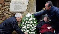 Lancara's Mayor, Dario Pineiro (R), late Cuban ex-President Fidel Castro's cousin Manuela Argiz (C), 103, and former Lancara Mayor, Eladio Capon, lay flowers outside the abandoned small limestone house of Castro's father, on which a plaque reads, 