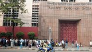 People stand in a queue outside the Reserve Bank of India during a nationwide strike called by major trade unions to protest against demonetisation in Kolkata on November 28, 2016. AFP / Dibyangshu SARKAR