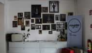 Entrance of the hotel shows pictures of staff who are refugees (Showkat Shafi / Al Jazeera) 